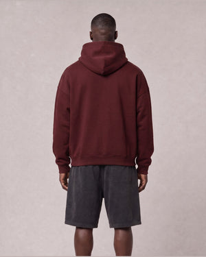 Essential Oversized Hoodie in Dark Red, back view on model