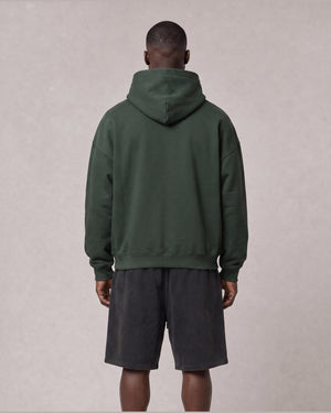 Essential Oversized Hoodie in Green, back view on model