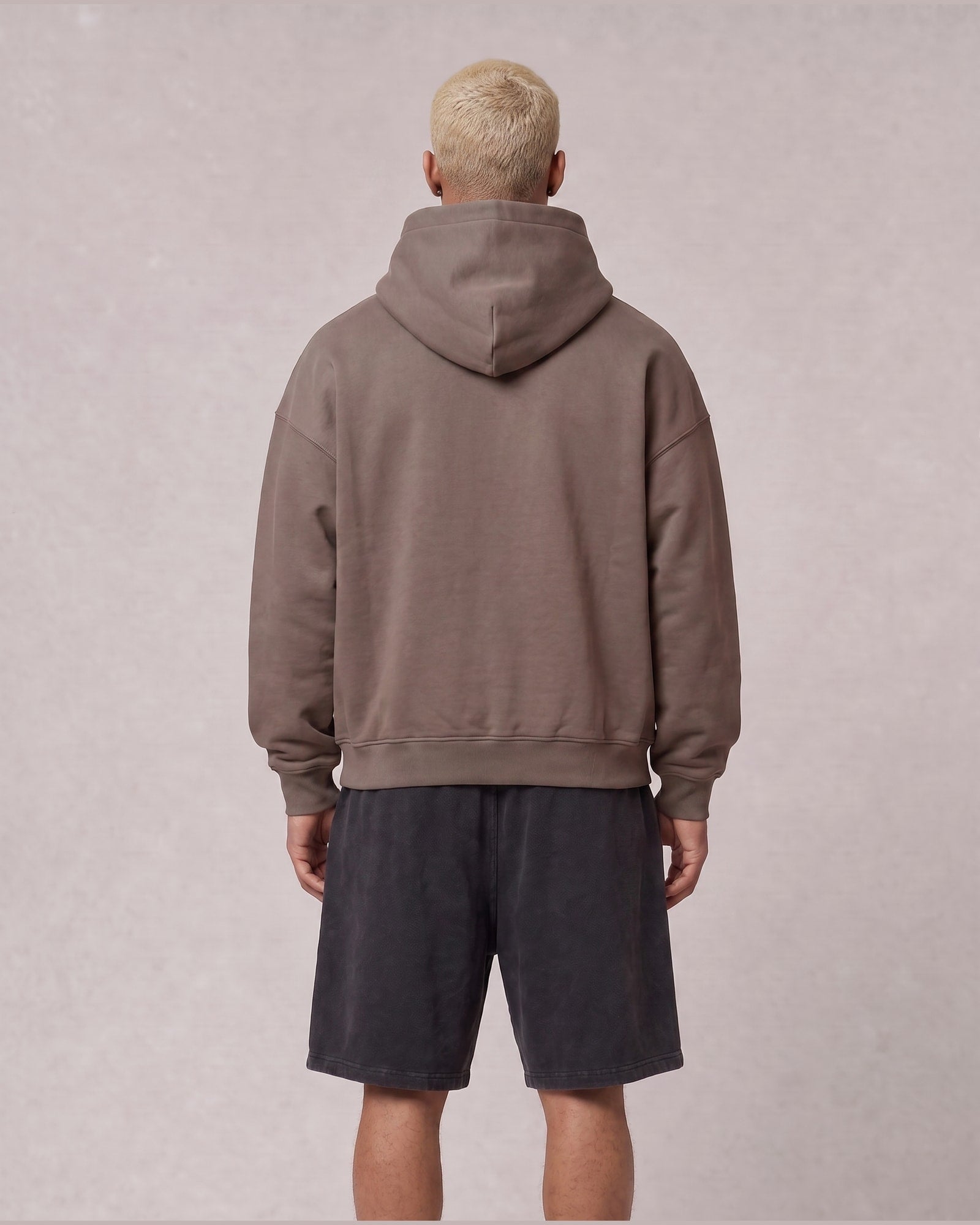 Essential Oversized Hoodie in Brown, back view on model